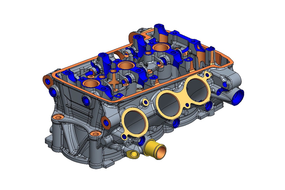 הדמיית CAD רשמית של ראש הצילינדר החדש למנוע ה-Moto2 של טריומף — רינדור הנדסי צבעוני של יחידת שלושה צילינדרים על רקע לבן, שרטוט ולא צילום